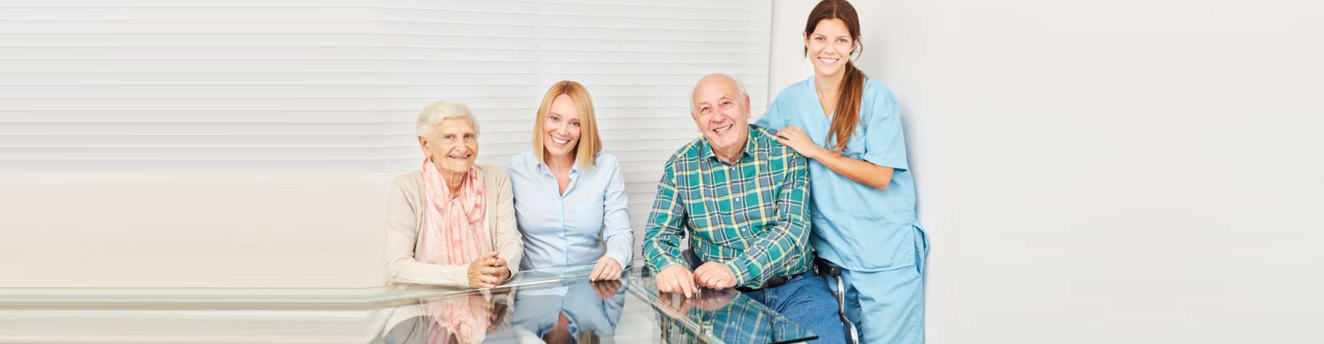 senior couple with the caregiver and adult woman smiling